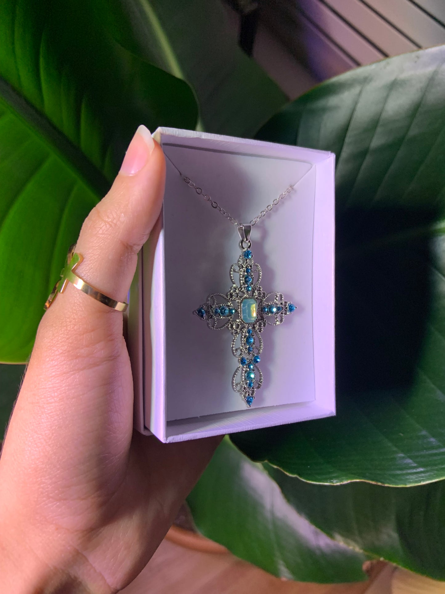 Detailed silver and blue cross necklace