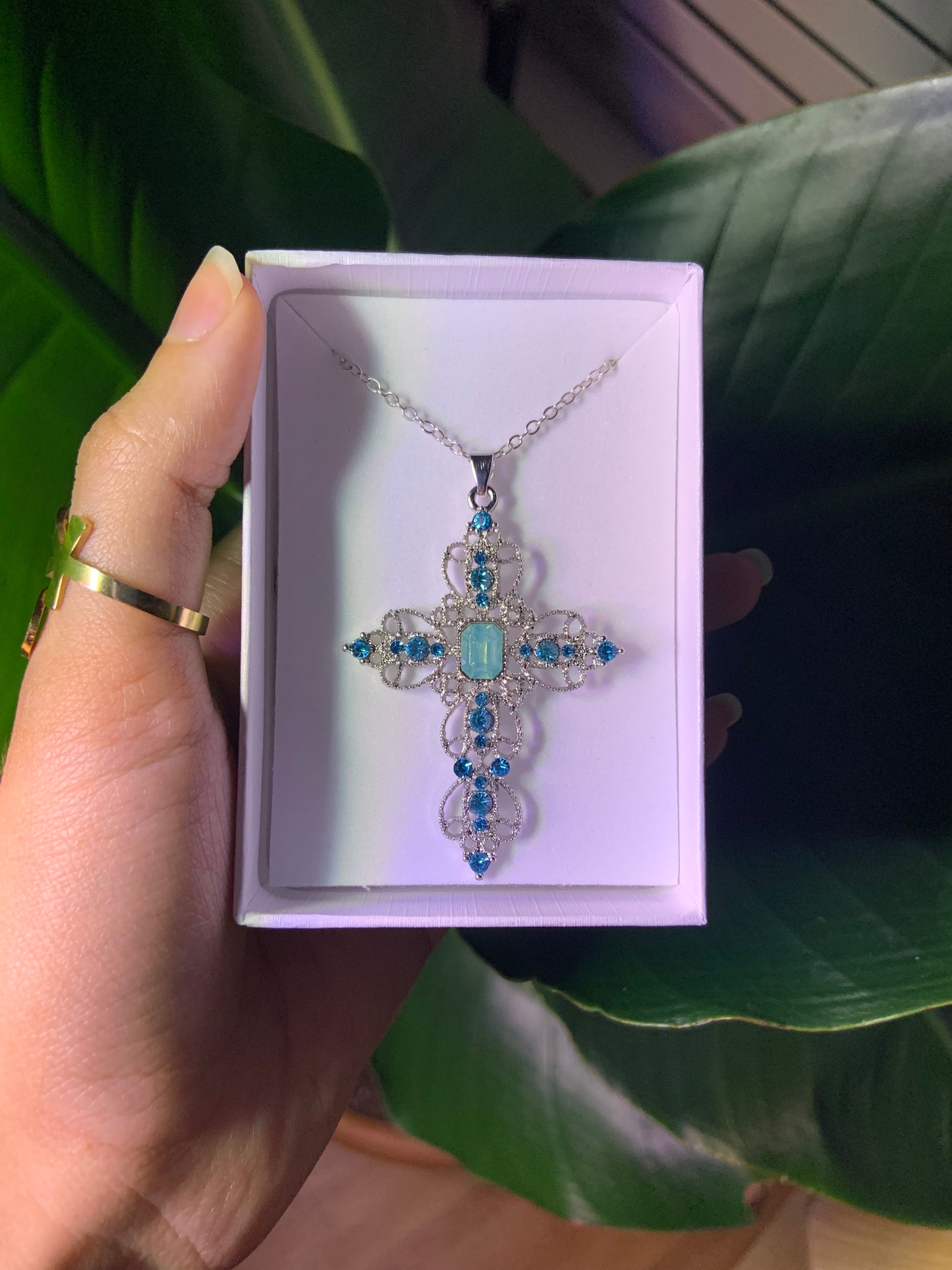 Detailed silver and blue cross necklace